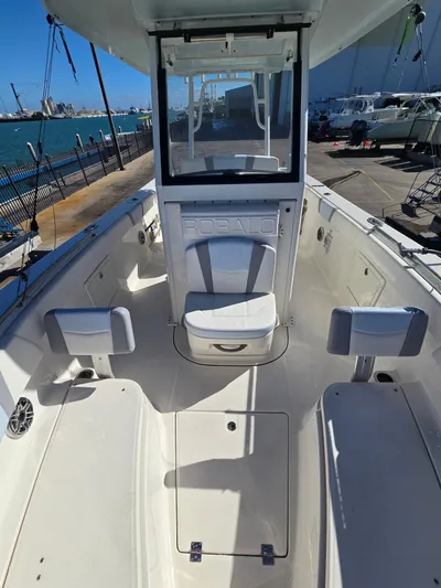 No Regrets Yacht Photos Pics Robalo R272 Center Console 2022 on a dock with ocean view.