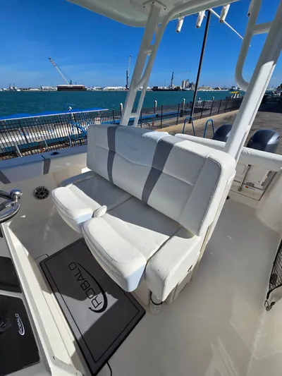 No Regrets Yacht Photos Pics 2022 Robalo R272 Center Console with white seating by the water.
