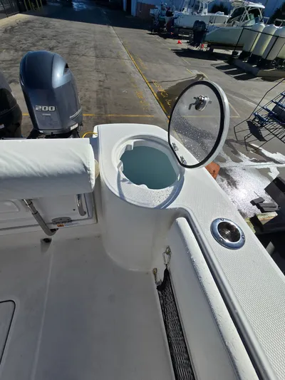 No Regrets Yacht Photos Pics Robalo R272 Center Console 2022 with open storage compartment and motor.