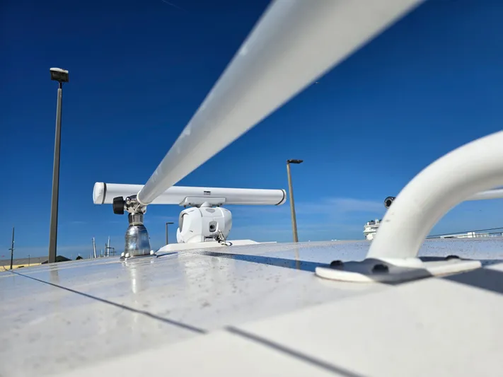 No Regrets Yacht Photos Pics Robalo R272 Center Console 2022 with radar against blue sky.