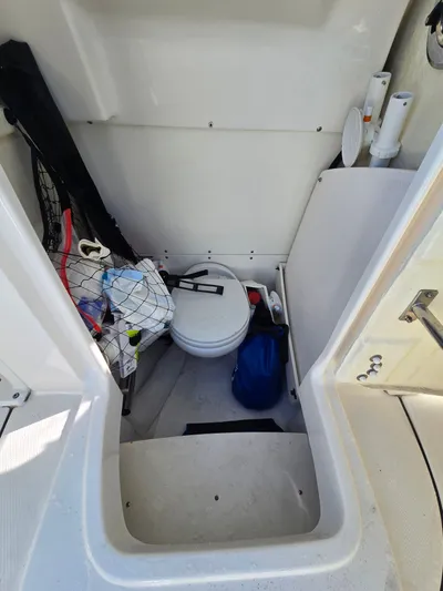 No Regrets Yacht Photos Pics Interior of 2022 Robalo R272 Center Console with storage and toilet.