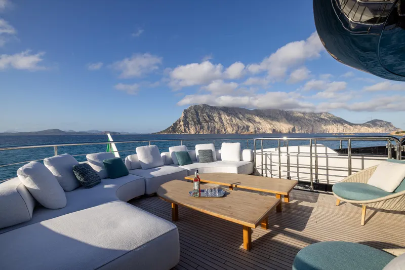 Filippetti F100 Yacht Photos Pics Luxurious 2026 Filippetti F100 yacht deck with elegant seating, ocean view, and scenic mountains.