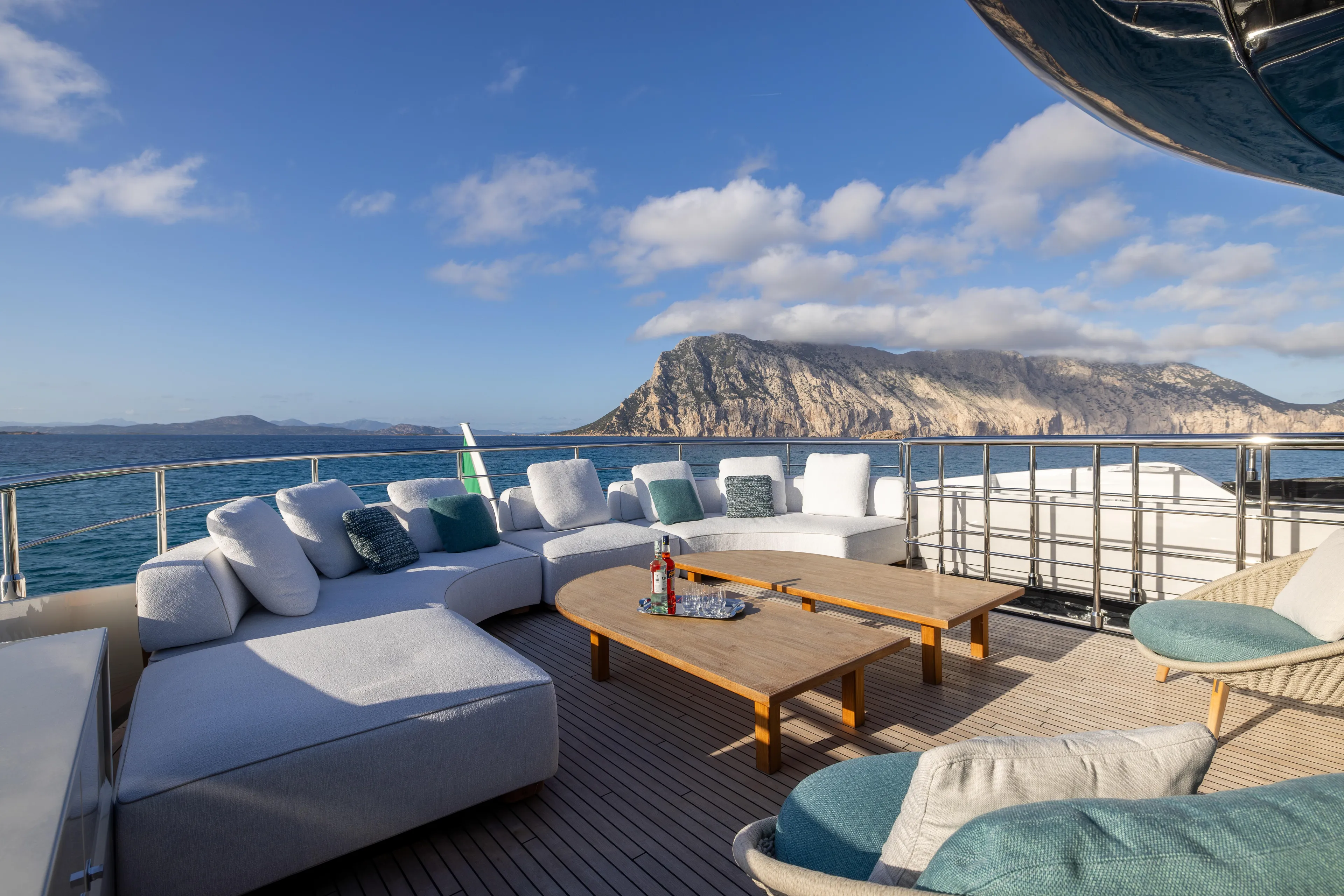 Filippetti F100 Yacht Photos Pics Luxurious Filippetti F100 yacht deck with comfortable seating, ocean view, and scenic mountains, 2026 model.