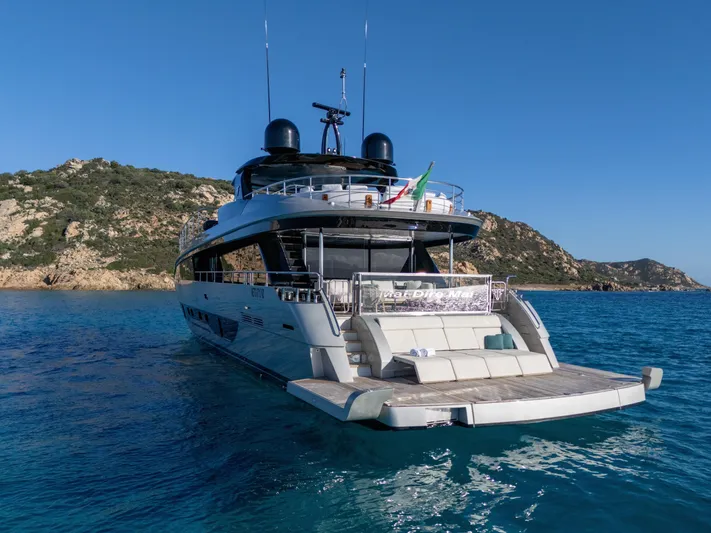 Filippetti F100 Yacht Photos Pics Luxurious 2026 Filippetti F100 yacht on serene blue waters near rocky coastline.