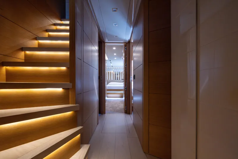 Filippetti F100 Yacht Photos Pics Luxurious interior of 2026 Filippetti F100 yacht with illuminated staircase and modern design.