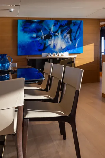 Filippetti F100 Yacht Photos Pics Interior of 2026 Filippetti F100 yacht with modern dining area and abstract blue artwork.