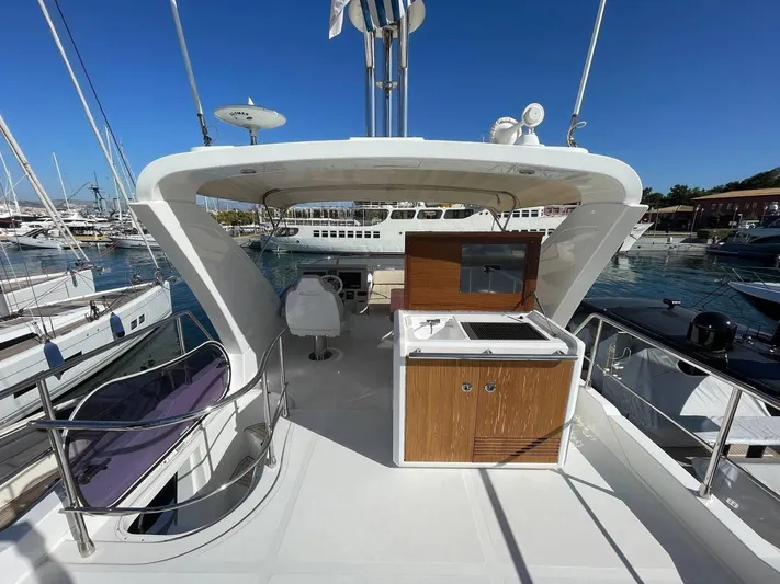 Vika Yacht Photos Pics Azimut Fly 50 yacht deck, 2016 model, featuring outdoor seating and kitchenette.