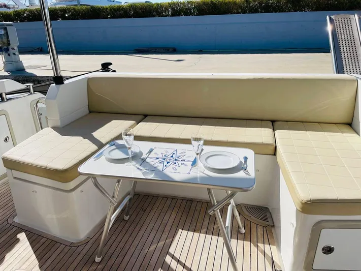Vika Yacht Photos Pics Outdoor seating area on 2016 Azimut Fly 50 yacht with table set for dining.
