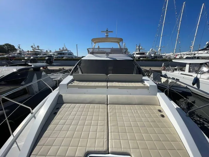 Vika Yacht Photos Pics 2016 Azimut Fly 50 yacht with spacious deck, docked in marina under clear blue sky.