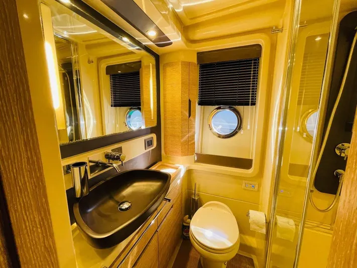 Vika Yacht Photos Pics Luxurious bathroom in 2016 Azimut Fly 50 yacht with modern fixtures and porthole window.