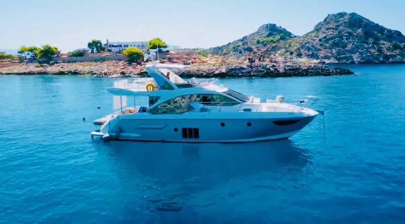 Vika Yacht Photos Pics Azimut Fly 50 yacht, 2016 model, anchored in serene blue waters with scenic island backdrop.