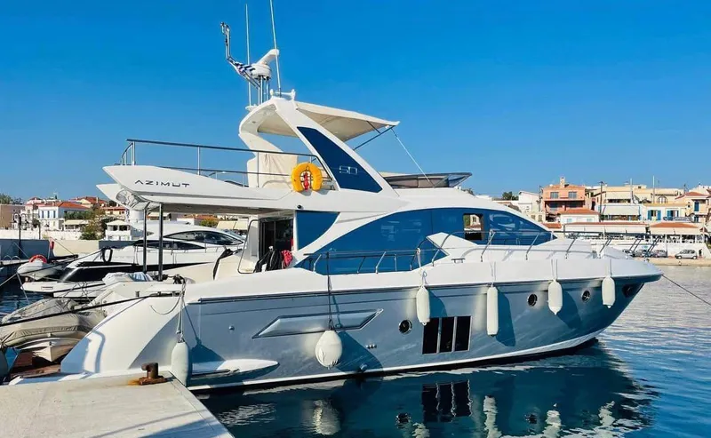 Vika Yacht Photos Pics 2016 Azimut Fly 50 yacht docked in a marina under clear blue skies.