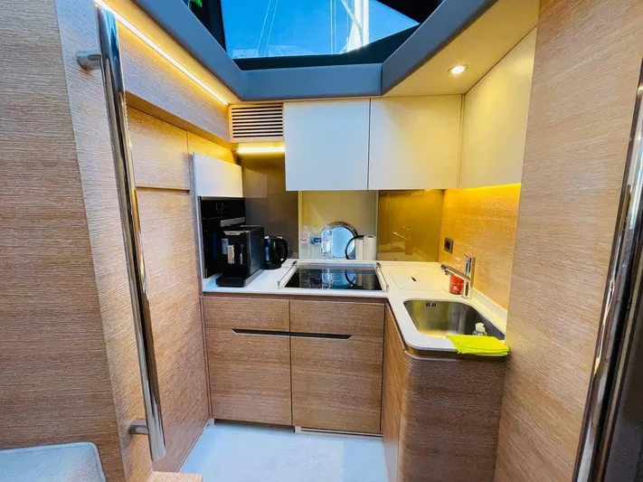 Vika Yacht Photos Pics Modern kitchen interior of 2016 Azimut Fly 50 yacht with wood finish and appliances.