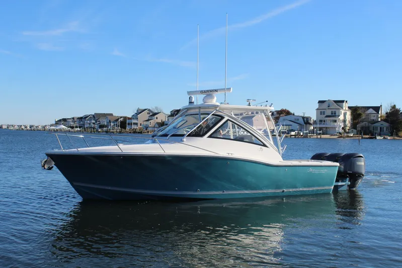 Mary Michele Yacht Photos Pics 2022 Albemarle 30 Express boat on calm water near coastal homes.