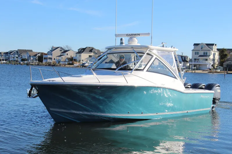 Mary Michele Yacht Photos Pics 2022 Albemarle 30 Express boat on calm water near coastal homes.