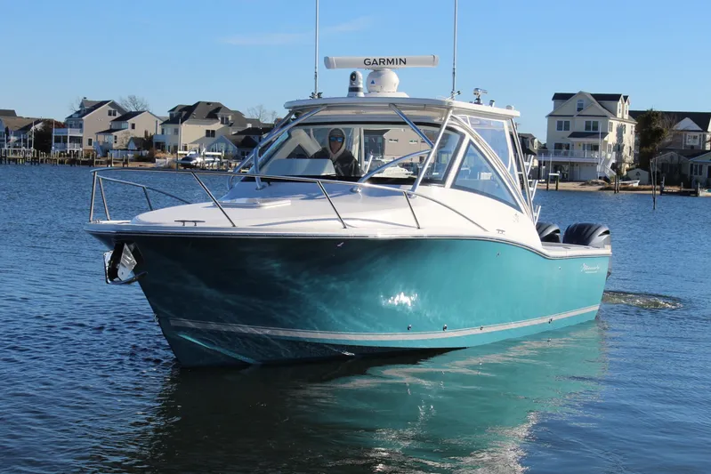 Mary Michele Yacht Photos Pics 2022 Albemarle 30 Express boat on water, with coastal homes in the background.