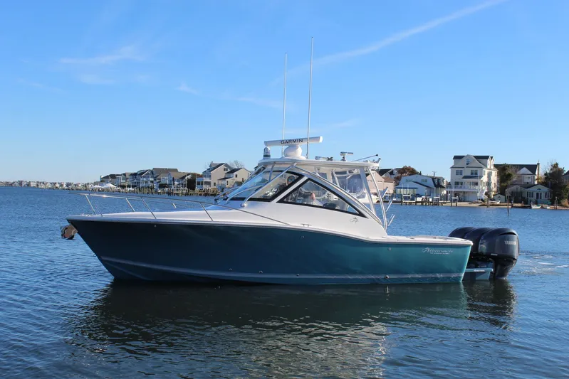 Mary Michele Yacht Photos Pics 2022 Albemarle 30 Express boat on calm water near coastal homes.