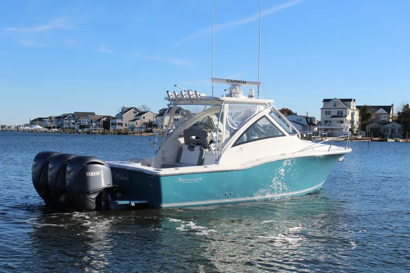 Mary Michele Yacht Photos Pics 2022 Albemarle 30 Express boat on water, featuring Yamaha engines, coastal houses in background.
