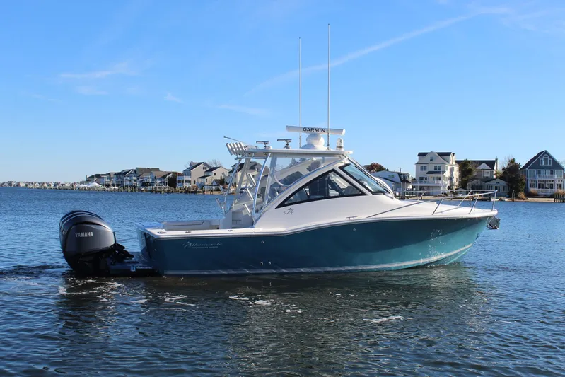 Mary Michele Yacht Photos Pics 2022 Albemarle 30 Express boat on water, with Yamaha outboard, near coastal homes.