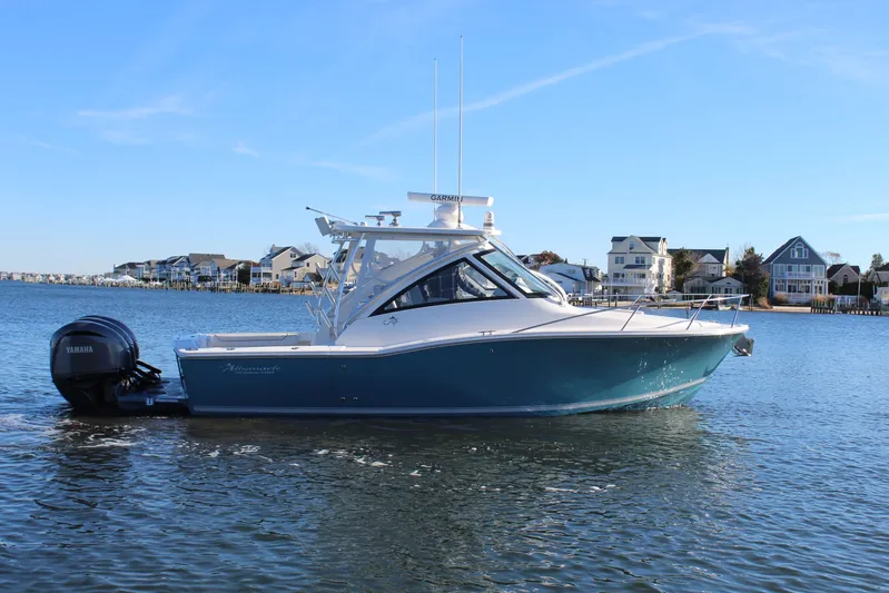 Mary Michele Yacht Photos Pics 2022 Albemarle 30 Express boat on calm water near coastal homes.