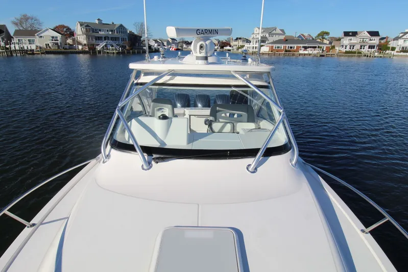 Mary Michele Yacht Photos Pics 2022 Albemarle 30 Express boat on water, with houses in the background.