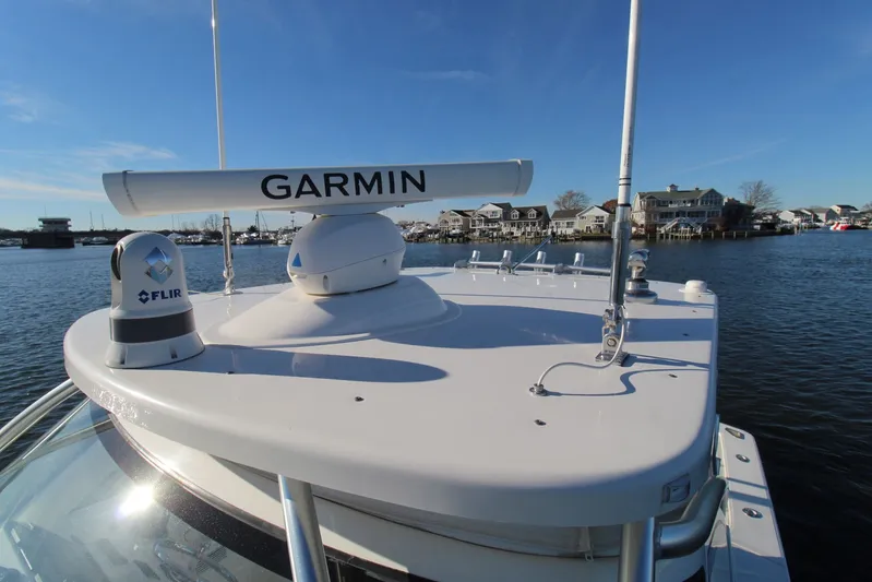 Mary Michele Yacht Photos Pics 2022 Albemarle 30 Express boat with Garmin and FLIR equipment on deck, docked near waterfront homes.