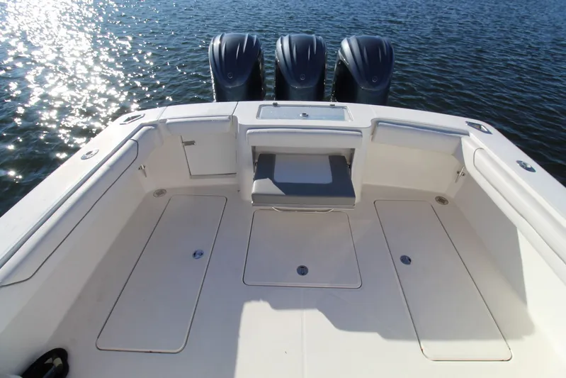 Mary Michele Yacht Photos Pics 2022 Albemarle 30 Express boat deck with triple outboard engines on water.