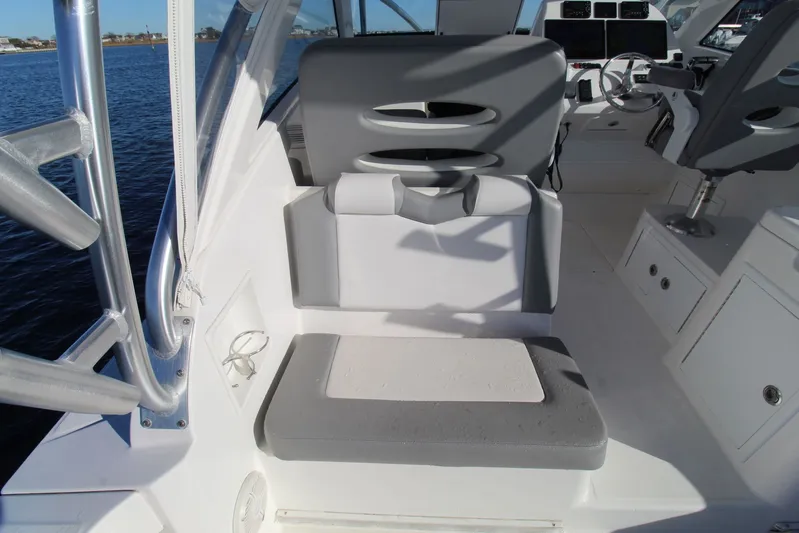 Mary Michele Yacht Photos Pics 2022 Albemarle 30 Express boat interior with seating and helm, on calm water.