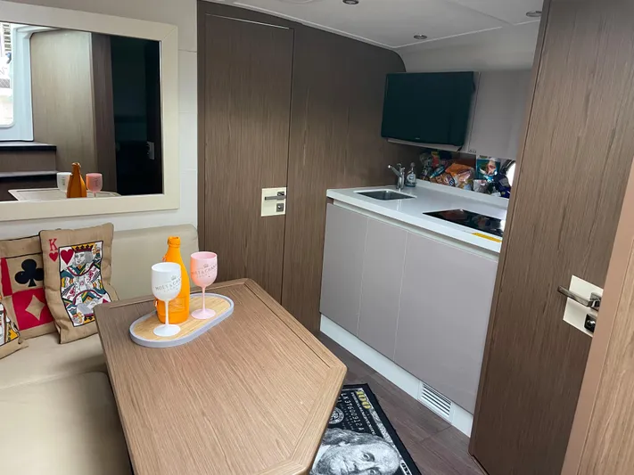  Yacht Photos Pics Interior of 2018 Beneteau Gran Turismo 40 yacht with modern kitchen and cozy seating area.