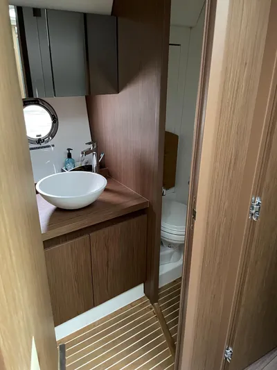  Yacht Photos Pics 2018 Beneteau Gran Turismo 40 yacht bathroom with modern sink and wooden cabinetry.