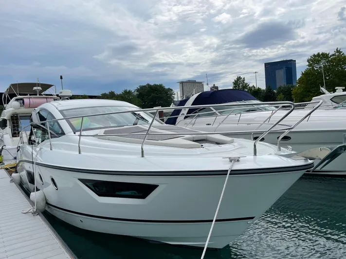  Yacht Photos Pics 2018 Beneteau Gran Turismo 40 yacht docked at marina under cloudy sky.