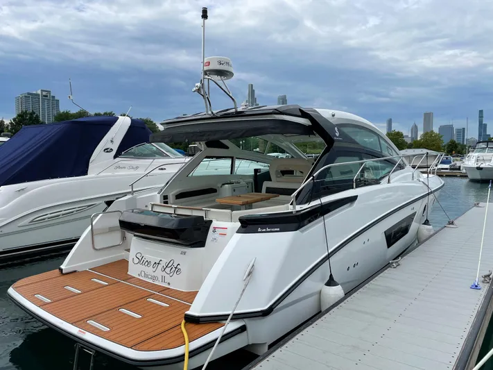  Yacht Photos Pics 2018 Beneteau Gran Turismo 40 yacht docked at marina, city skyline in background.
