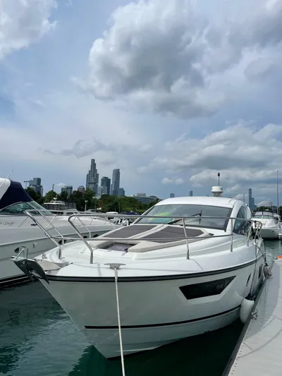  Yacht Photos Pics 2018 Beneteau Gran Turismo 40 yacht docked with city skyline in background.