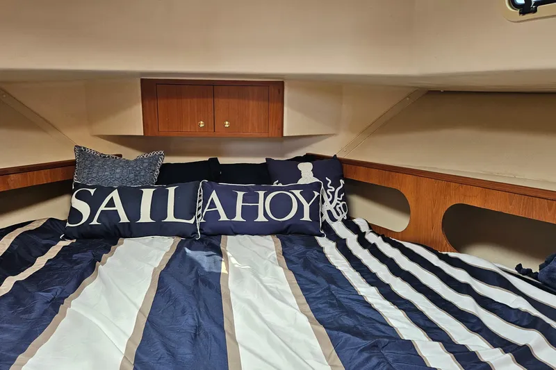  Yacht Photos Pics Cozy cabin interior of 1999 Mainship 430 Trawler with nautical-themed bedding.