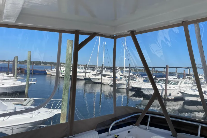  Yacht Photos Pics 1999 Mainship 430 Trawler docked at marina with other boats in view.