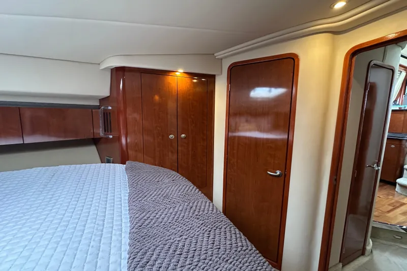 Our Alibi Yacht Photos Pics Luxurious 2004 Sea Ray 420 Sedan Bridge cabin with wood finishes and cozy bedding.