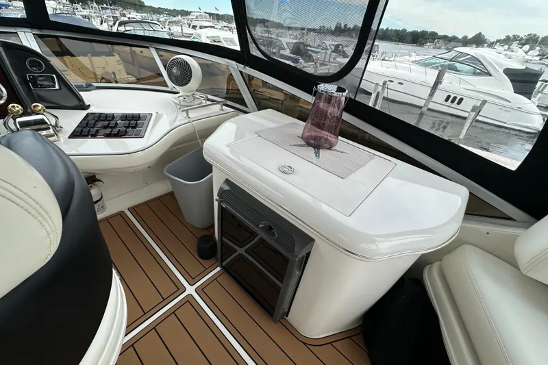 Our Alibi Yacht Photos Pics 2004 Sea Ray 420 Sedan Bridge interior with helm, seating, and marina view.