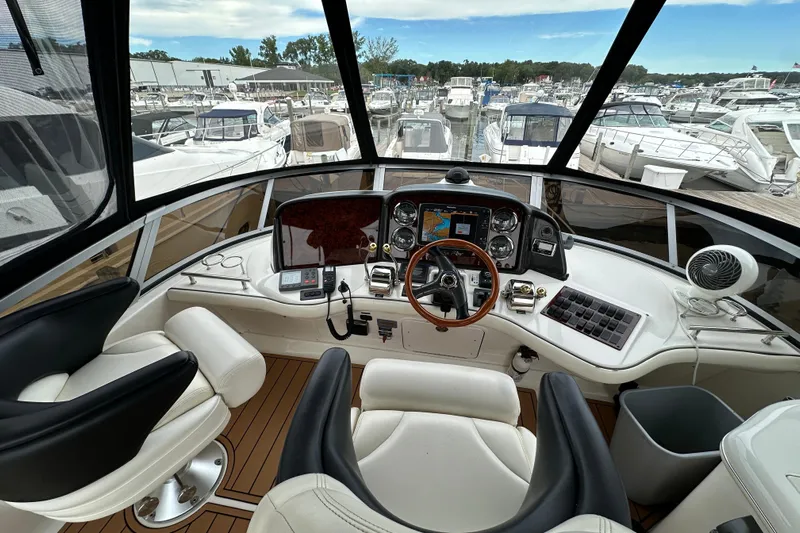 Our Alibi Yacht Photos Pics 2004 Sea Ray 420 Sedan Bridge helm with modern controls and marina view.