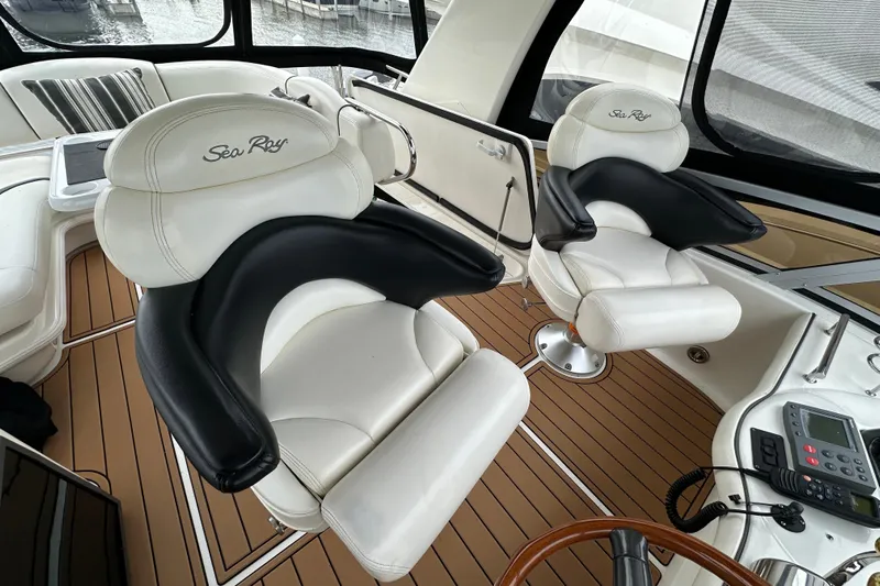 Our Alibi Yacht Photos Pics Luxurious interior of 2004 Sea Ray 420 Sedan Bridge with plush seating and modern controls.