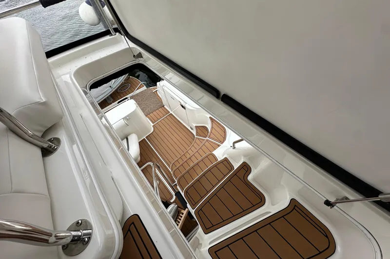 Our Alibi Yacht Photos Pics 2004 Sea Ray 420 Sedan Bridge interior with teak flooring and white seating.