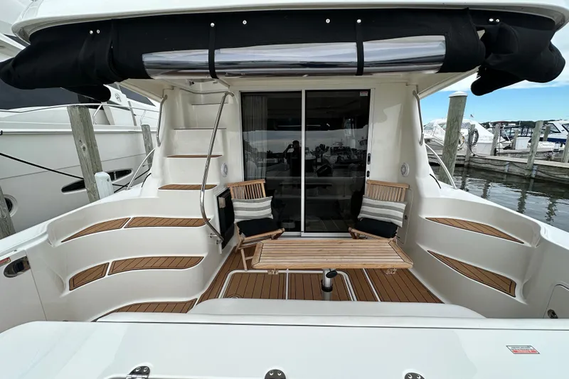 Our Alibi Yacht Photos Pics 2004 Sea Ray 420 Sedan Bridge yacht with elegant deck seating and wooden accents.