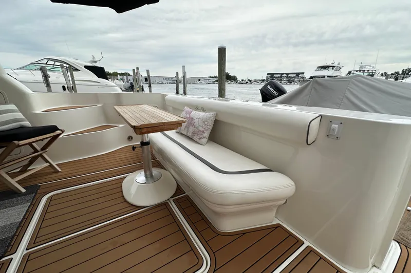 Our Alibi Yacht Photos Pics Luxurious 2004 Sea Ray 420 Sedan Bridge yacht interior with elegant seating and wooden table.