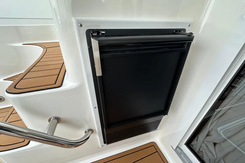 Our Alibi Yacht Photos Pics Built-in refrigerator on 2004 Sea Ray 420 Sedan Bridge yacht with teak flooring.