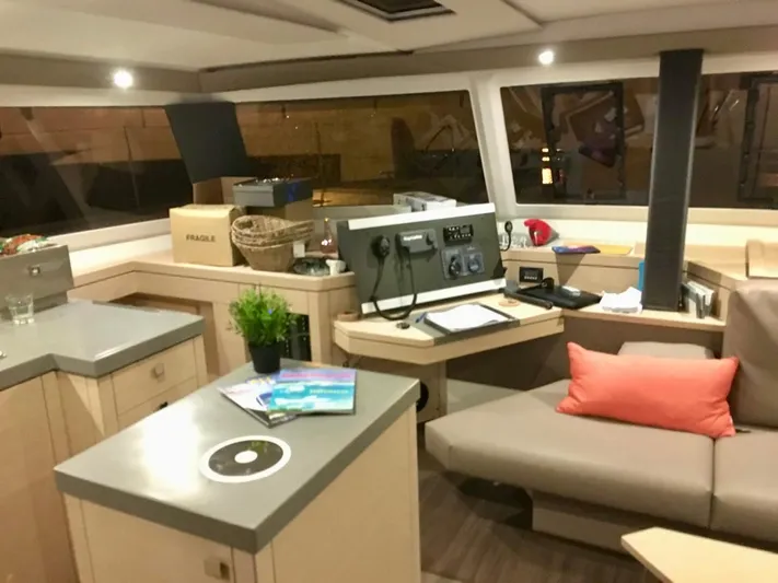 Tranquilo Yacht Photos Pics Interior of 2018 Fountaine Pajot Saona 47 catamaran with modern navigation station and cozy seating.