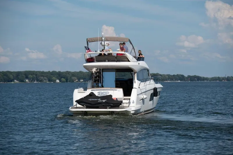  Yacht Photos Pics 2012 Prestige 500 yacht cruising on a serene lake under a clear blue sky.