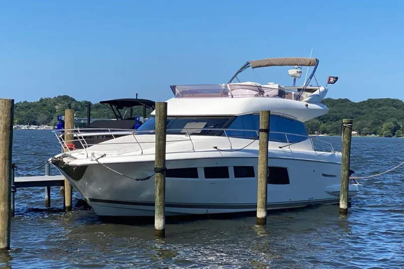  Yacht Photos Pics 2012 Prestige 500 yacht docked on a serene lake with lush green surroundings.