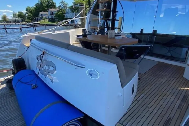  Yacht Photos Pics Prestige 500 yacht, 2012 model, docked with outdoor seating and table on deck.