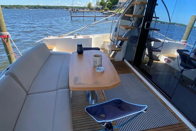  Yacht Photos Pics Luxury 2012 Prestige 500 yacht deck with seating, table, and scenic water view.