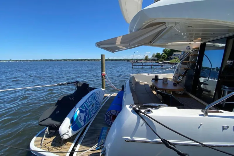  Yacht Photos Pics Luxury 2012 Prestige 500 yacht docked with paddleboard and scenic lake view.