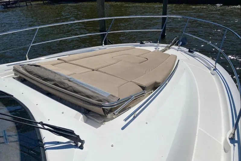  Yacht Photos Pics 2012 Prestige 500 yacht with sunbathing deck, docked on calm water.